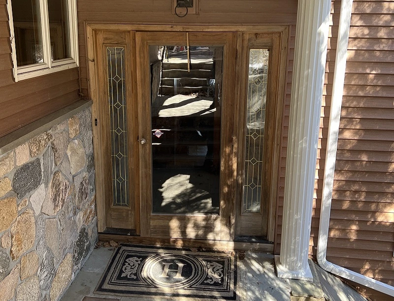 Worn out front door with sidelights